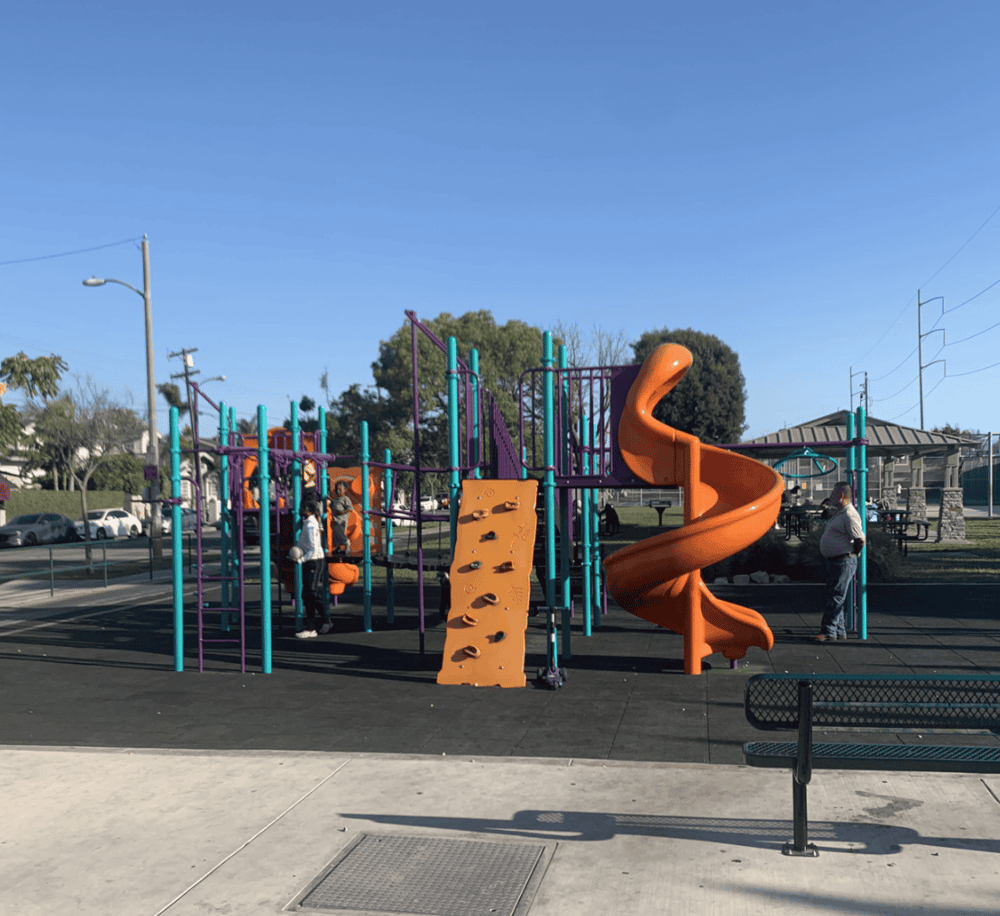 Colorful outdoor playground with slides and climbing structures for children.