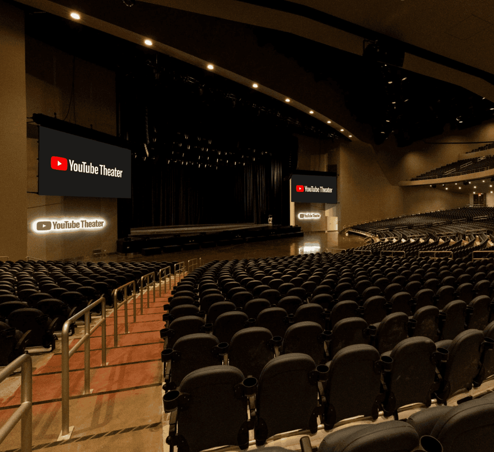 YouTube Theater auditorium with large screens, modern seating, and stage for video events and presentations.