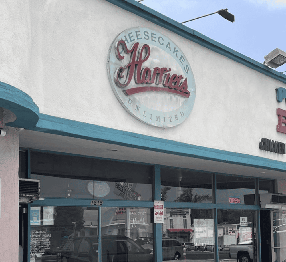 Cheesecake and chicken restaurant storefront with Harley’s signage and blue accents.