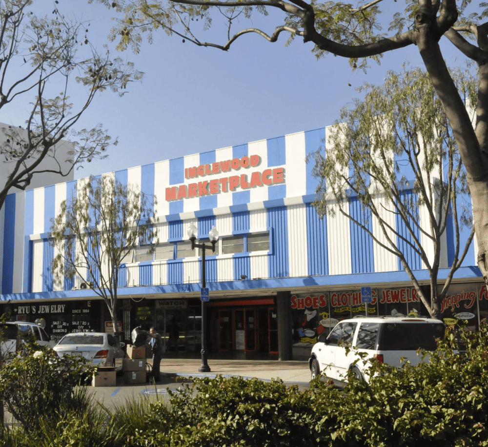 Colorful exterior of Inglewood Marketplace showcasing shopping and dining options in a lively retail center.