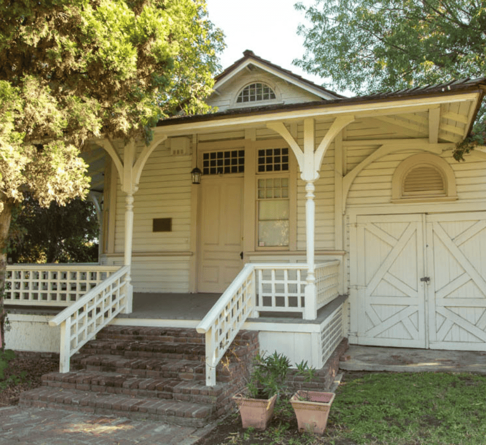 Charming vintage house exterior with wooden porch and classic architecture - ideal for real estate SEO.