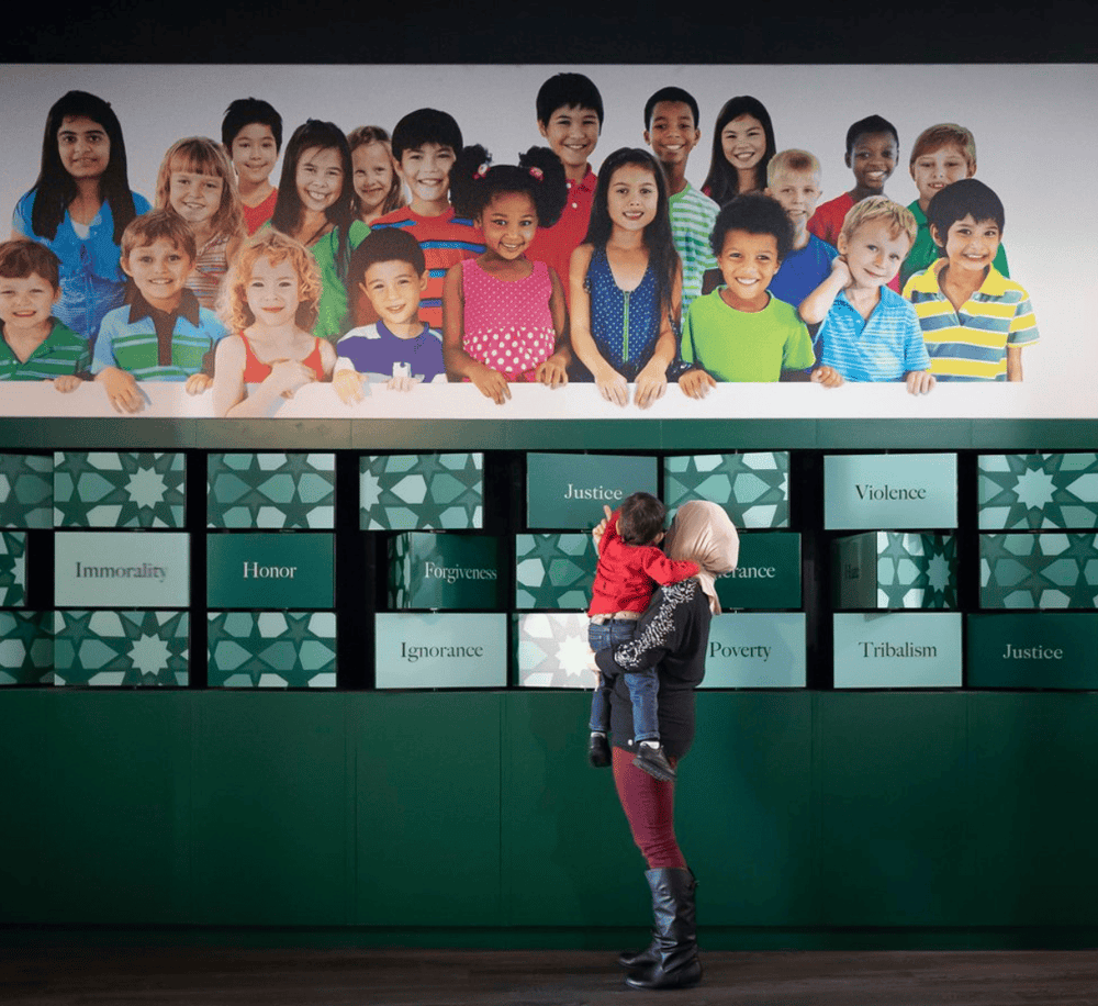 Bright group of diverse children at QuestForDirections educational display promoting kindness and understanding.