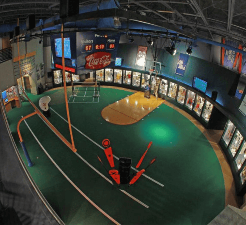 Indoor sports facility with basketball courts and entertainment area for family fun.