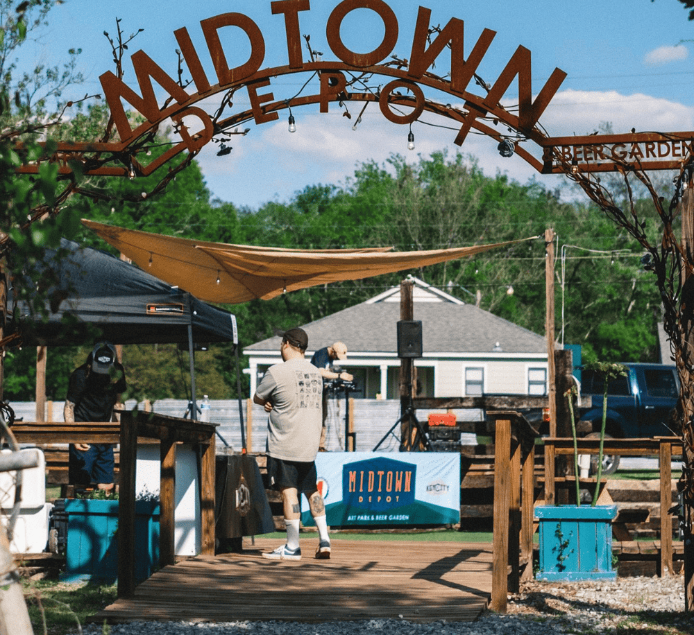 Outdoor craft beer garden at Midtown Depot, featuring local brews, live music, and a vibrant community atmosphere.