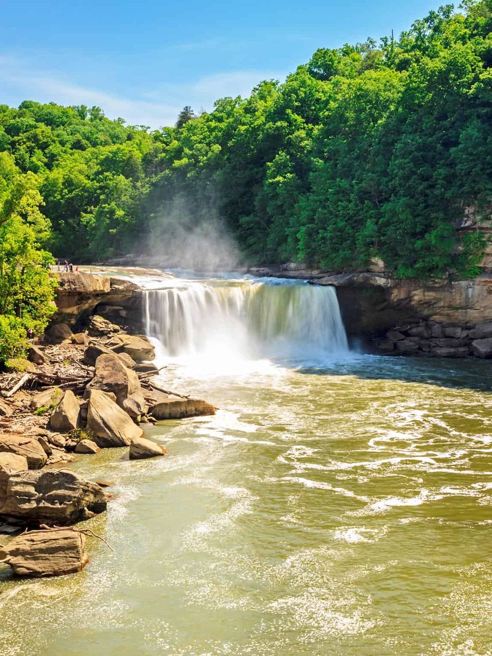 Vibrant waterfall in lush green forest, nature scenery, outdoor adventure, scenic destination.