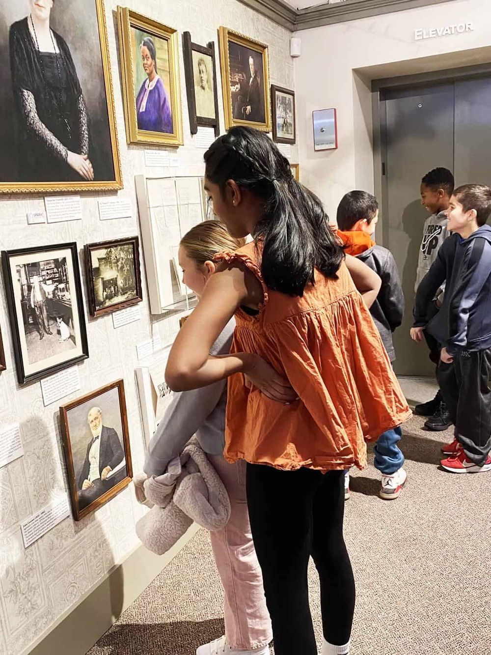 Historic art museum exploring portraits and historical photographs with children.