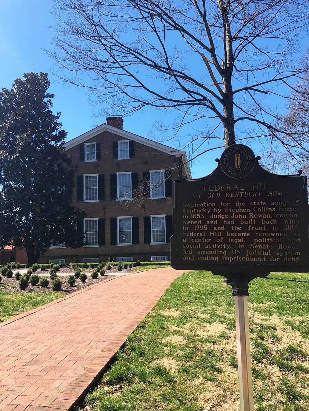 Historic Federal Hill house with informational plaque in Lexington, Kentucky.