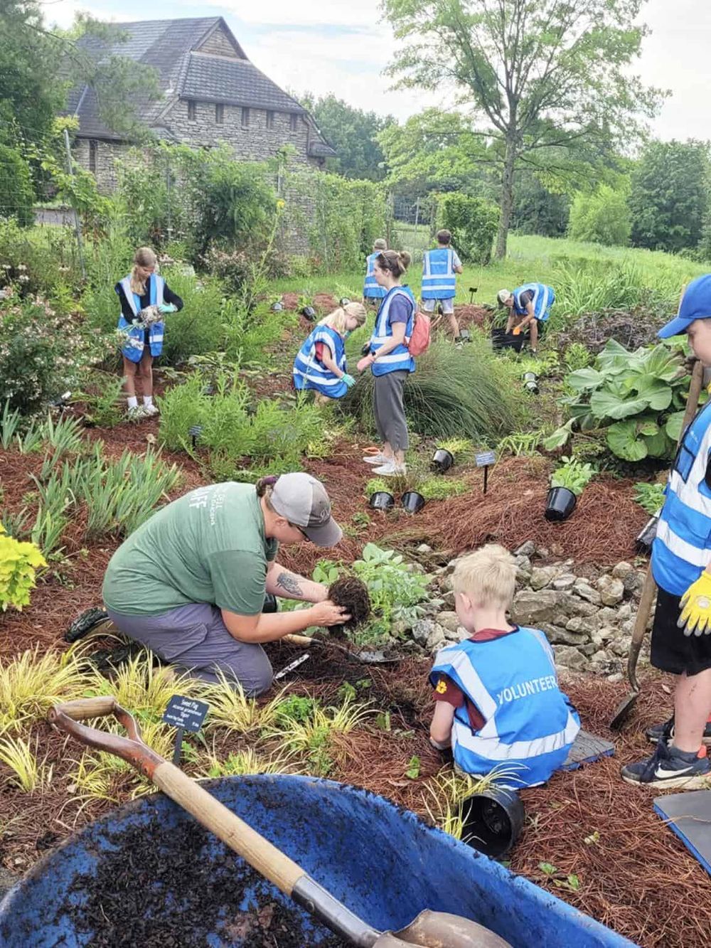 Volunteers planting garden at community environmental project event.