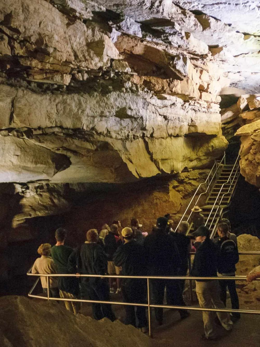 Ancient cave tour with guided group exploring impressive natural rock formations and underground scenery.