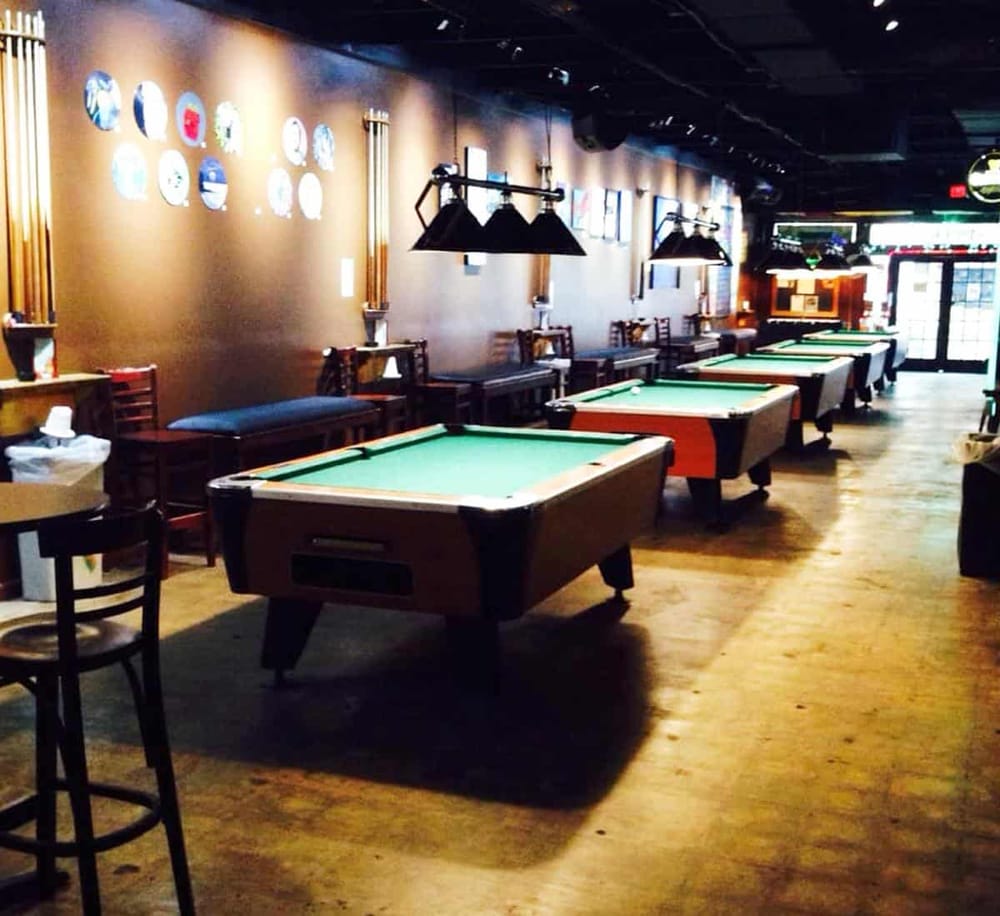 Pool tables in cozy bar setting inviting for billiards and fun gaming nights.