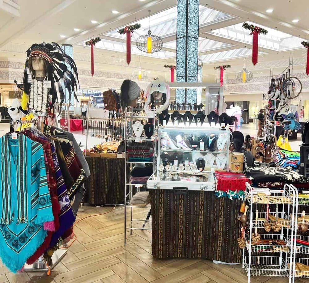 Colorful marketplace display of Mexican and indigenous handicrafts in shopping mall.