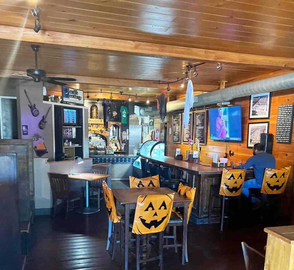Cozy bar with Halloween-themed decorations and wooden accents at QuestForDirections.