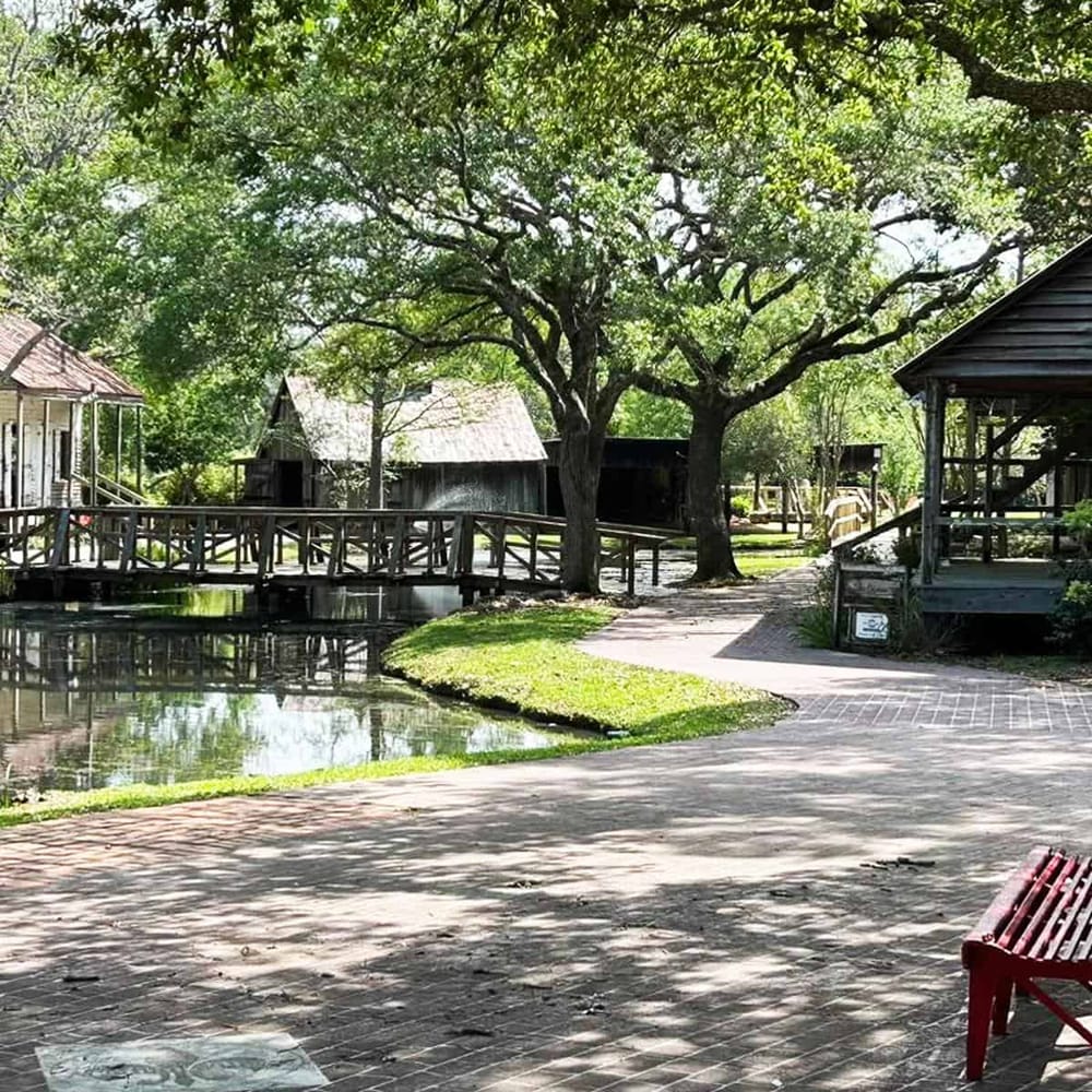 Peaceful outdoor park with water features and wooden structures, perfect for relaxation and outdoor activities.