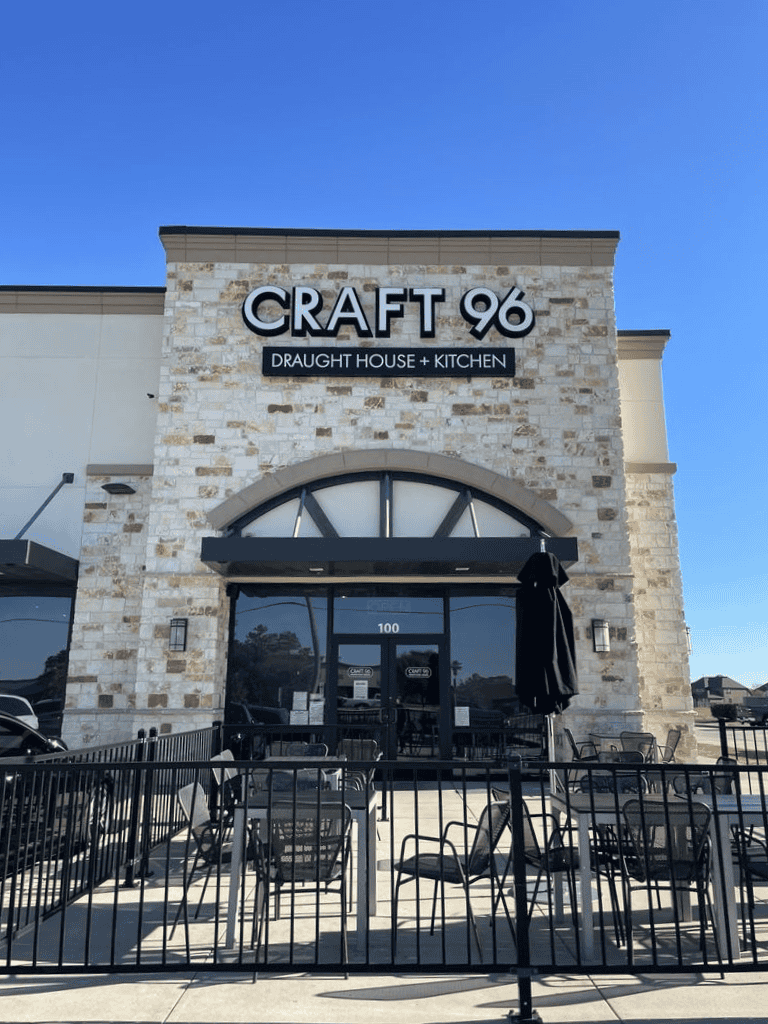 Craft 96 restaurant exterior with outdoor seating and modern design, specializing in craft beer and kitchen dishes.
