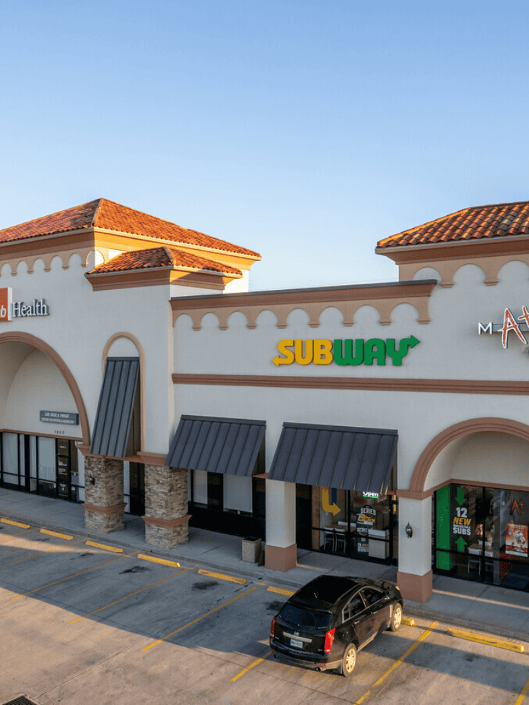 Subway sandwich shop exterior in shopping plaza, parking lot, QuestForDirections.