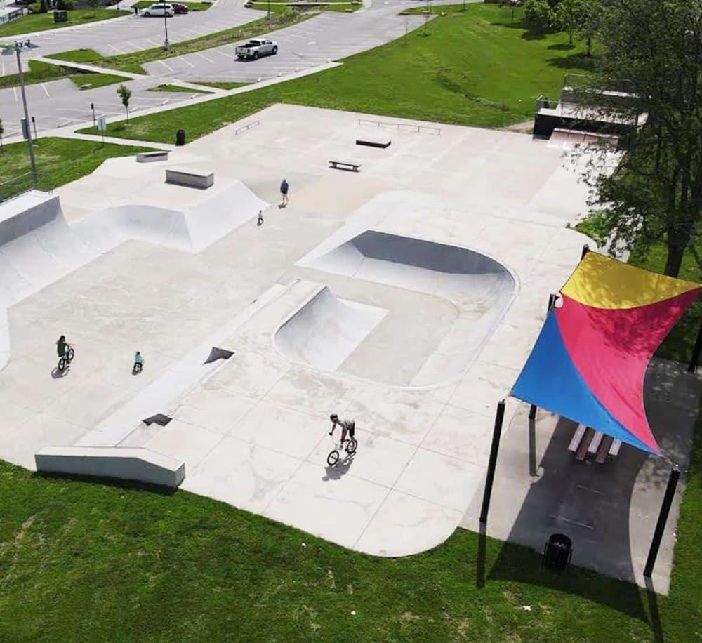 Bright skatepark with bowls and ramps in an outdoor setting, ideal for skateboarding and BMX tricks.