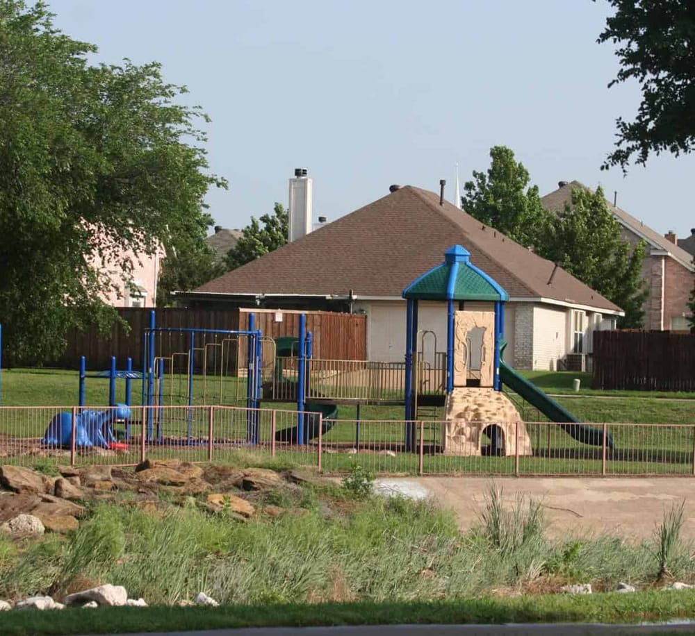 Colorful neighborhood playground with slide and climbing structure, ideal for kids’ outdoor fun and family activities.