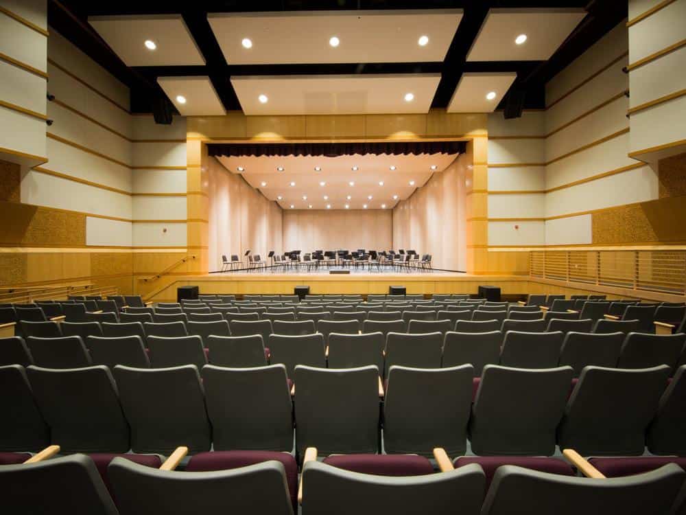 Modern theater with stage and seating for events and performances.