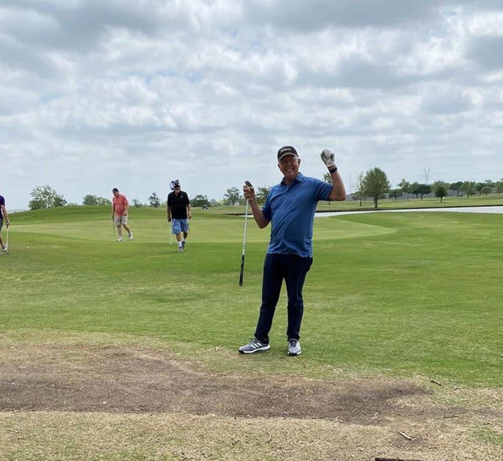 Enjoying a round of golf at a scenic golf course with friends, demonstrating outdoor sports and leisure activities.