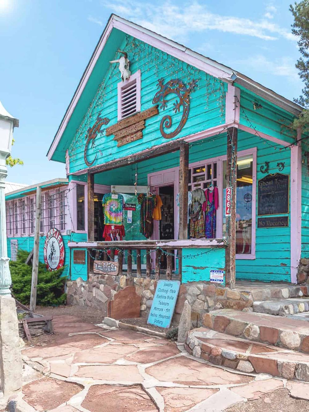 Colorful boutique shop on seaside street, vibrant storefront with shopping items, vacation shopping destination.