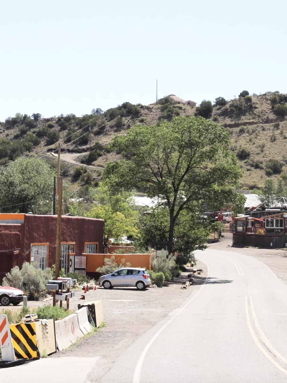 Scenic mountain view with a curved road, trees, and local businesses, highlighting directions and navigation in QuestForDirections.