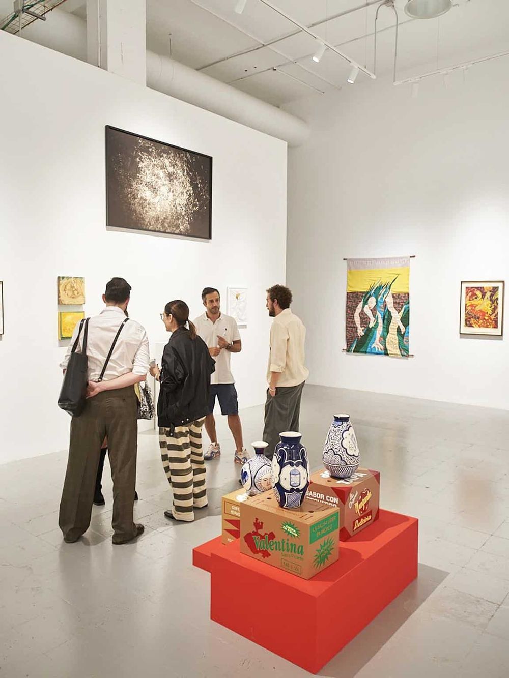 People viewing artwork at an art gallery or museum, enhancing cultural exploration and art appreciation.