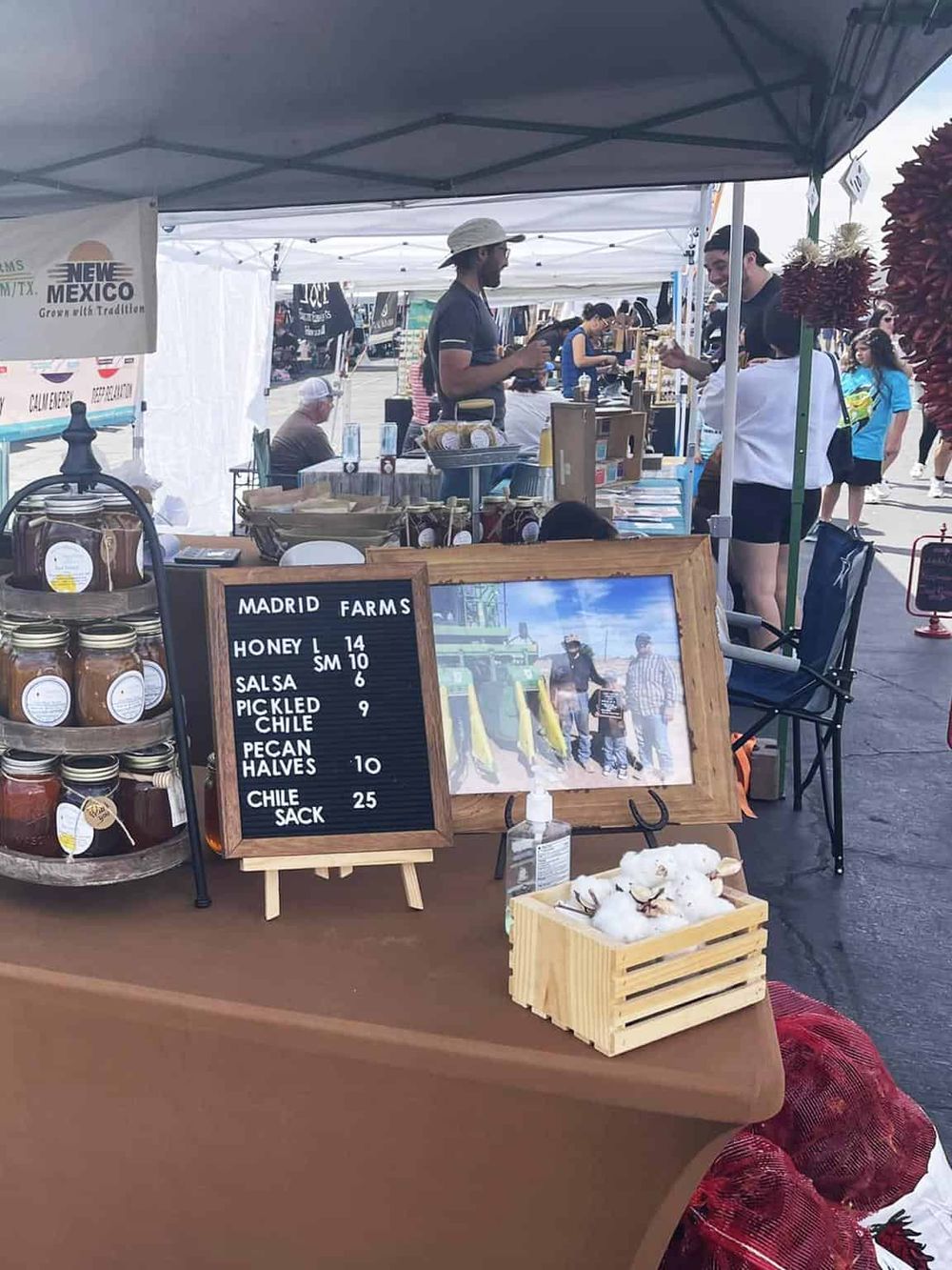 Fresh honey and traditional products at a vibrant outdoor farmers market in New Mexico.