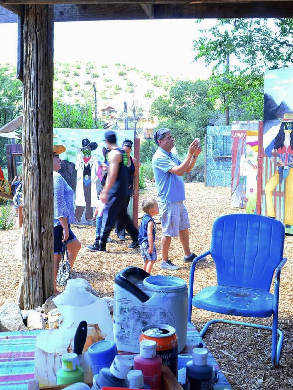 Colorful outdoor art festival with visitors enjoying vibrant murals and creative displays.