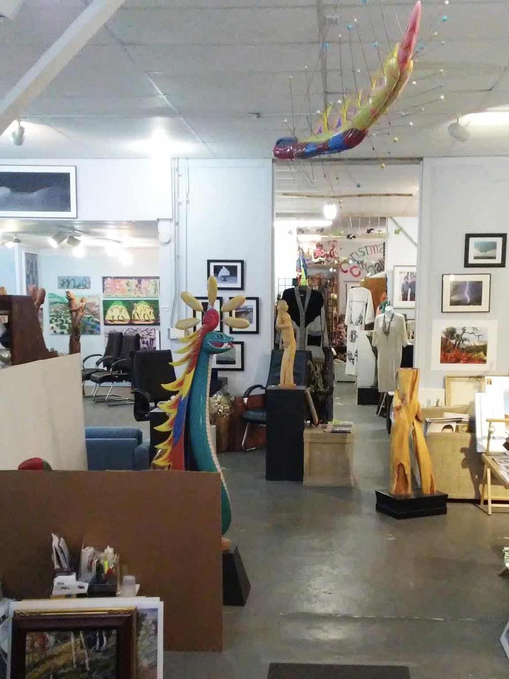 Colorful dragon sculpture at QuestForDirections art gallery, showcasing unique handcrafted artworks and home décor pieces.