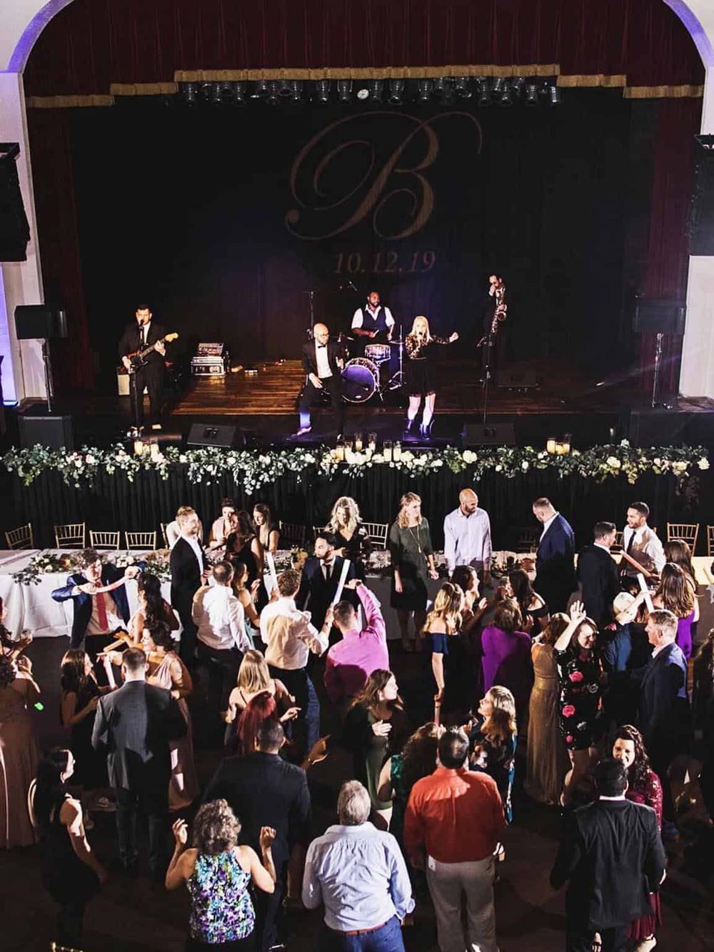 Live wedding reception with live band, dancing, and elegant event décor, celebrating a special occasion.