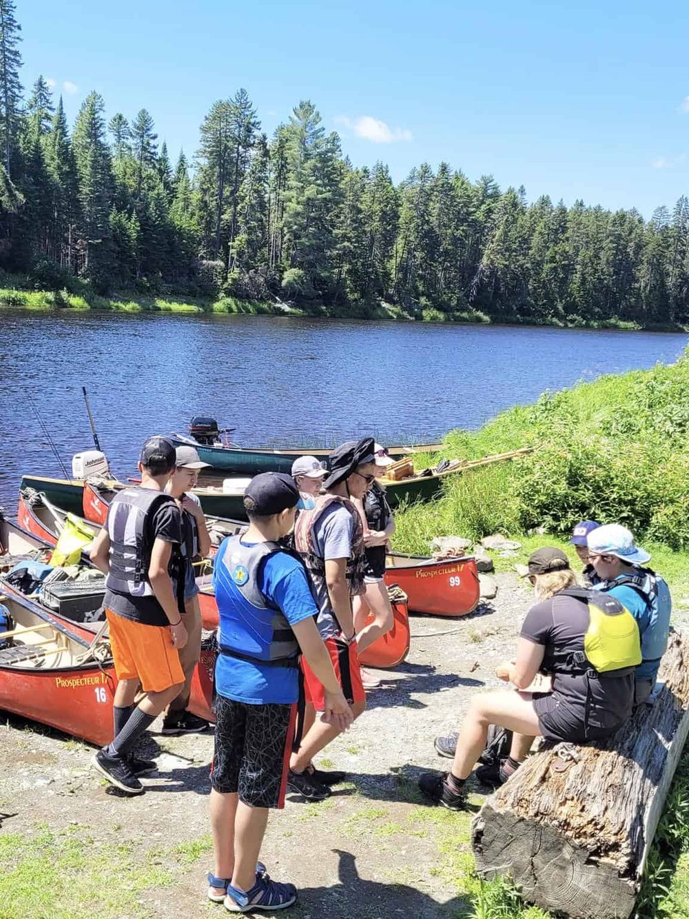 1. Friends preparing for kayaking on a scenic river in nature.