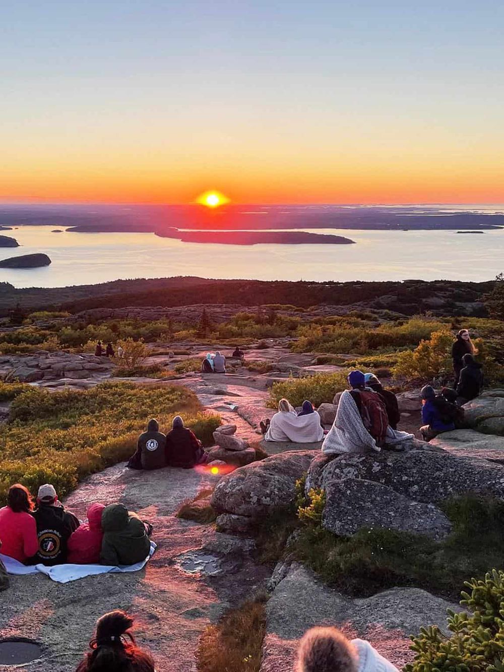 Sunset over scenic landscape with people watching, capturing outdoor adventure and nature exploration at QuestForDirections.