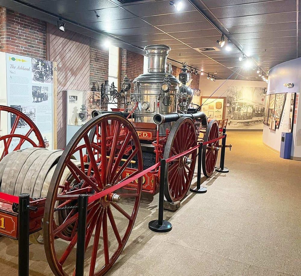 Vintage fire engine exhibit at a transportation history museum.