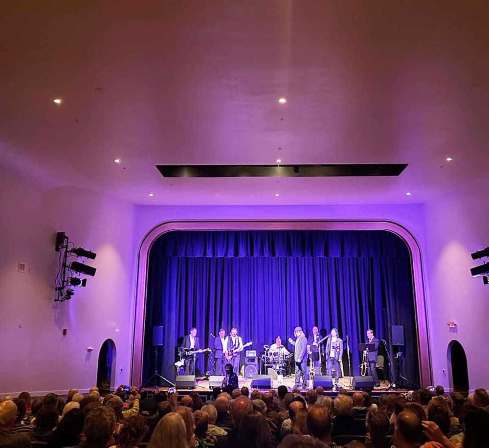 Vibrant stage performance at QuestForDirections event, showcasing live music and engaging audience experience.