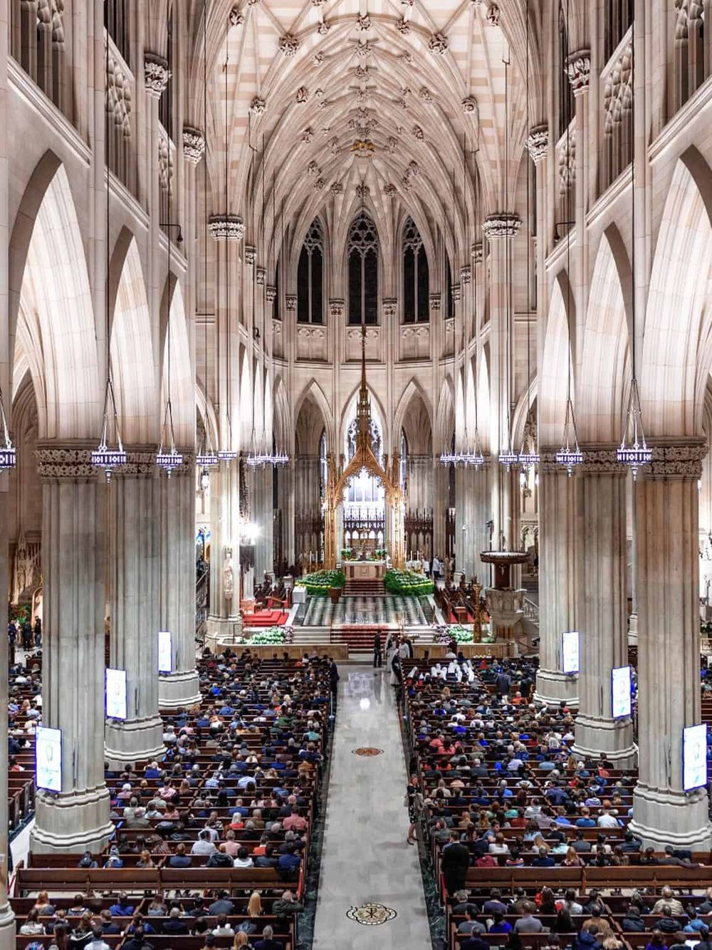 Stunning Gothic cathedral interior during a religious service, intricate architecture, and a large congregation.