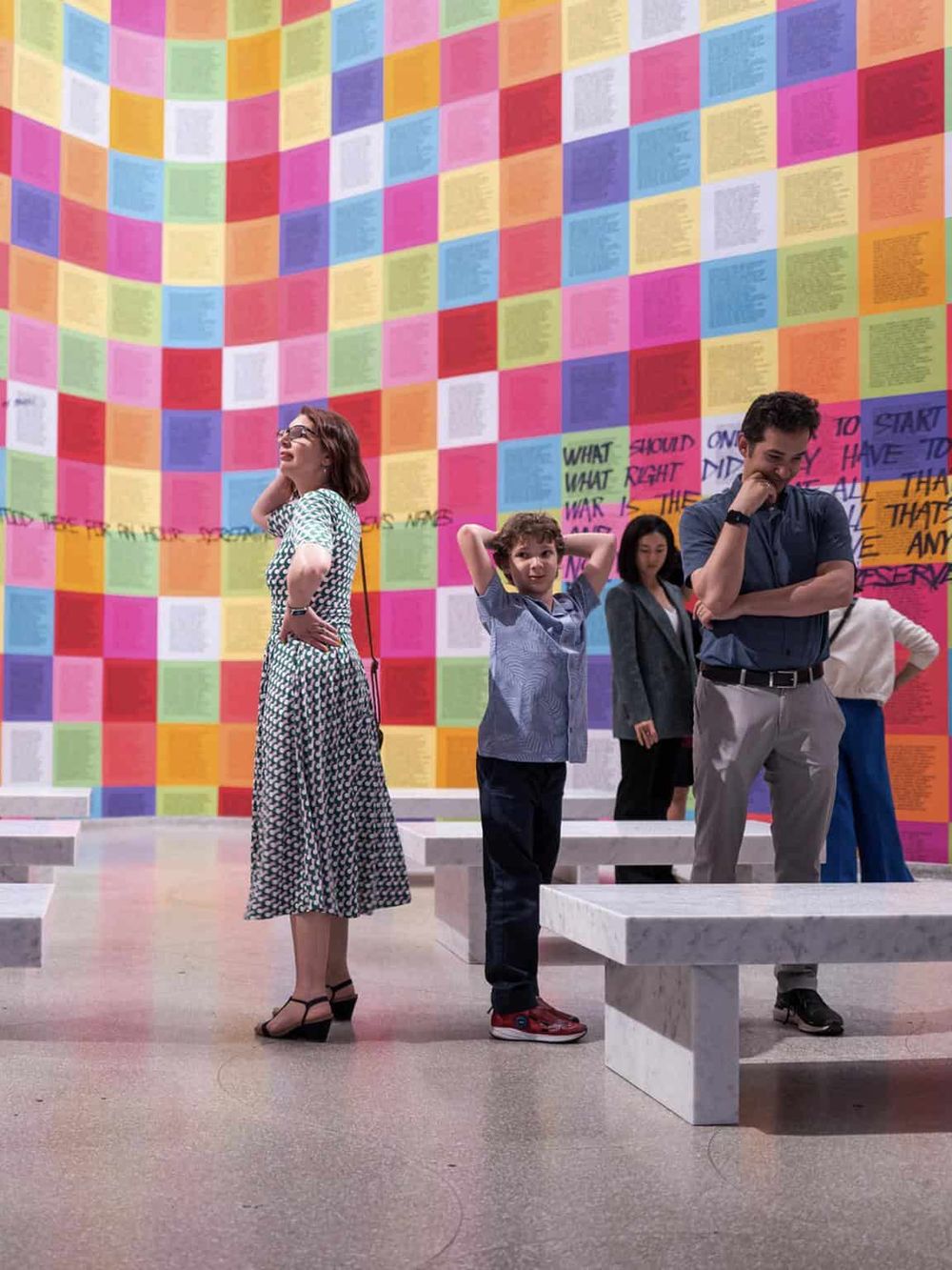 Colorful exhibition wall displays inspirational messages at QuestForDirections art installation.