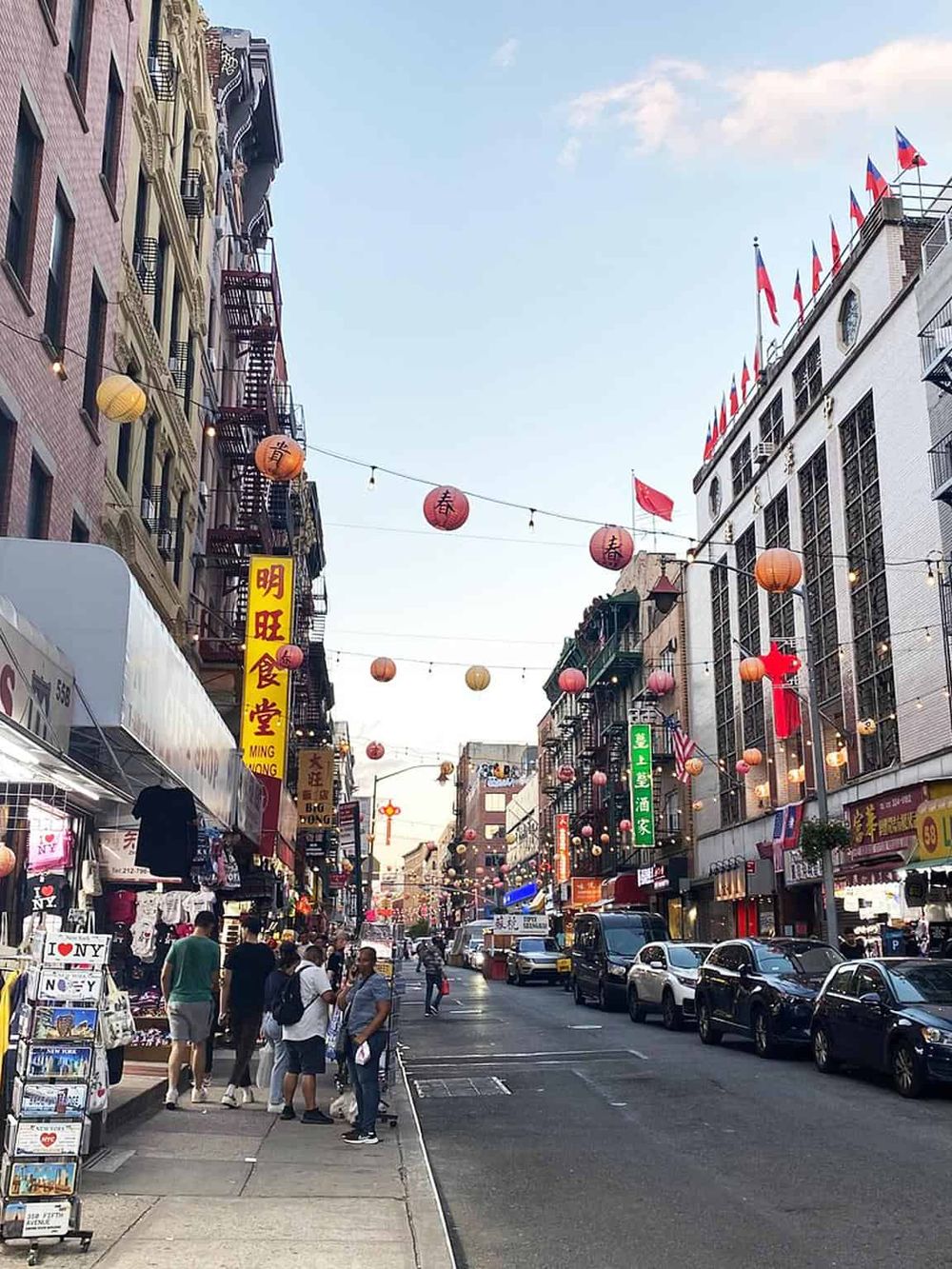 Bright Chinatown street scene with colorful lanterns, shops, and busy pedestrians, showcasing vibrant Asian culture and city life.