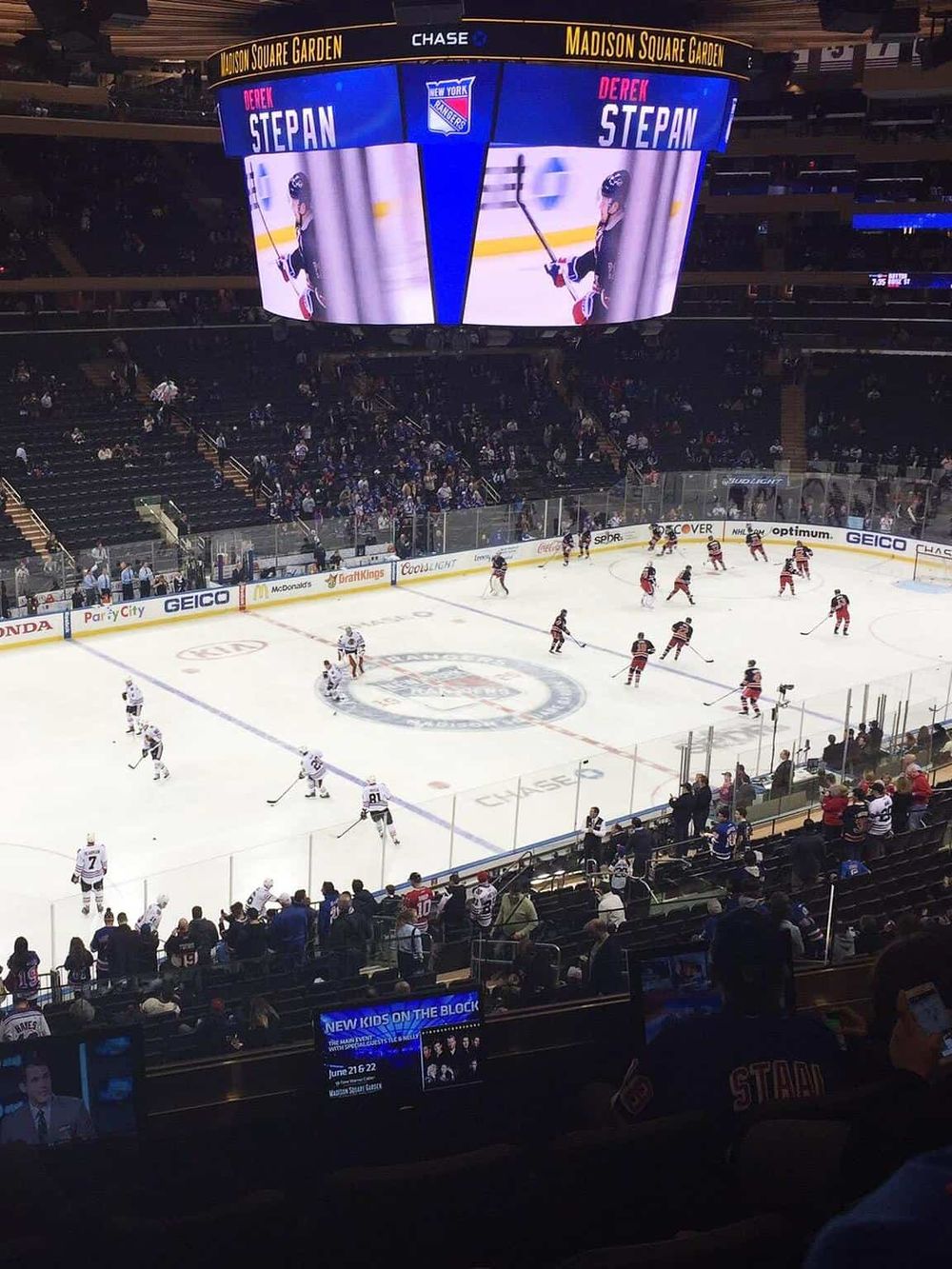 Exciting hockey game at Madison Square Garden, home of the New York Rangers, with fans enjoying live sports action.