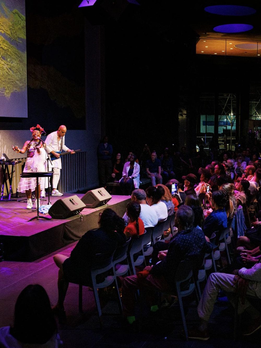 Vibrant live music performance at QuestForDirections event with diverse audience enjoying the show.