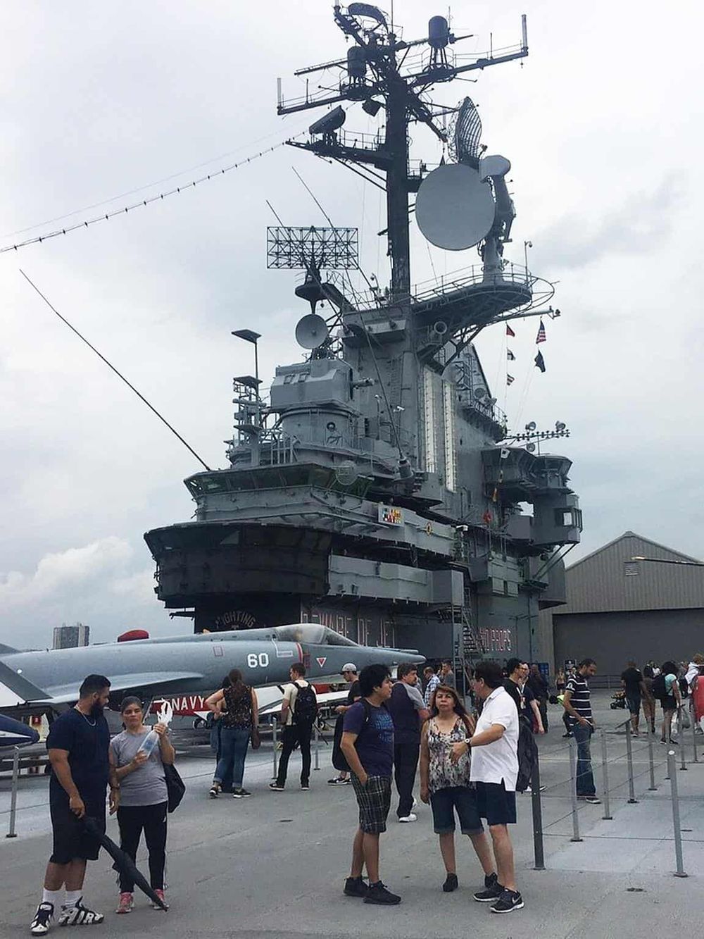 USS Midway aircraft carrier museum with fighter jet and visitors, San Diego, CA.