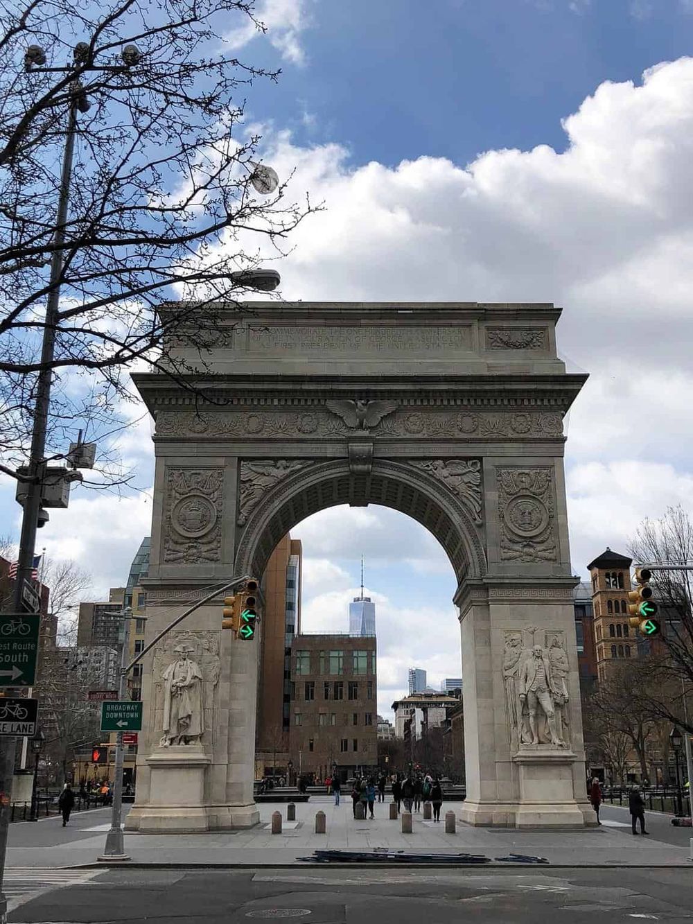 Majestic Washington Square Arch in NYC with One World Trade Center in background.