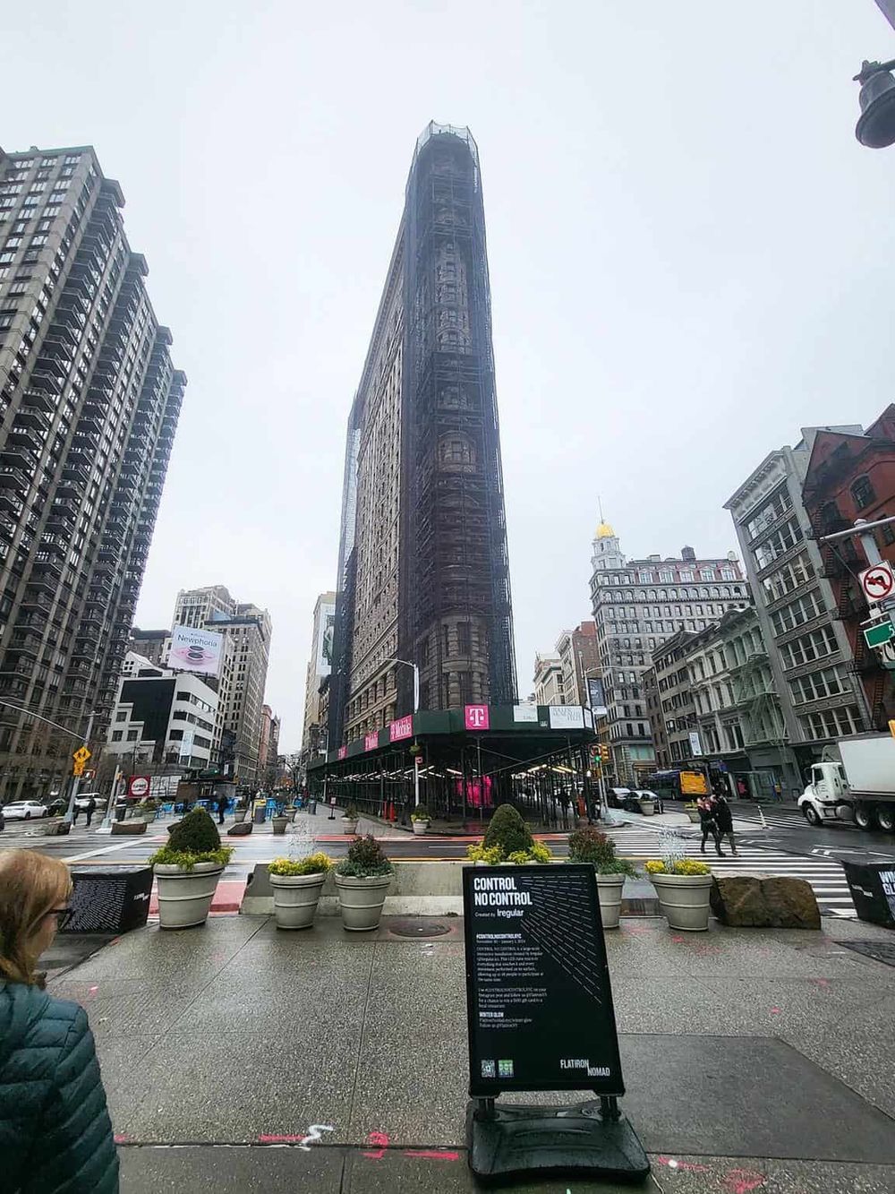 Steel skyscraper under construction in New York City with scaffolding and urban surroundings.