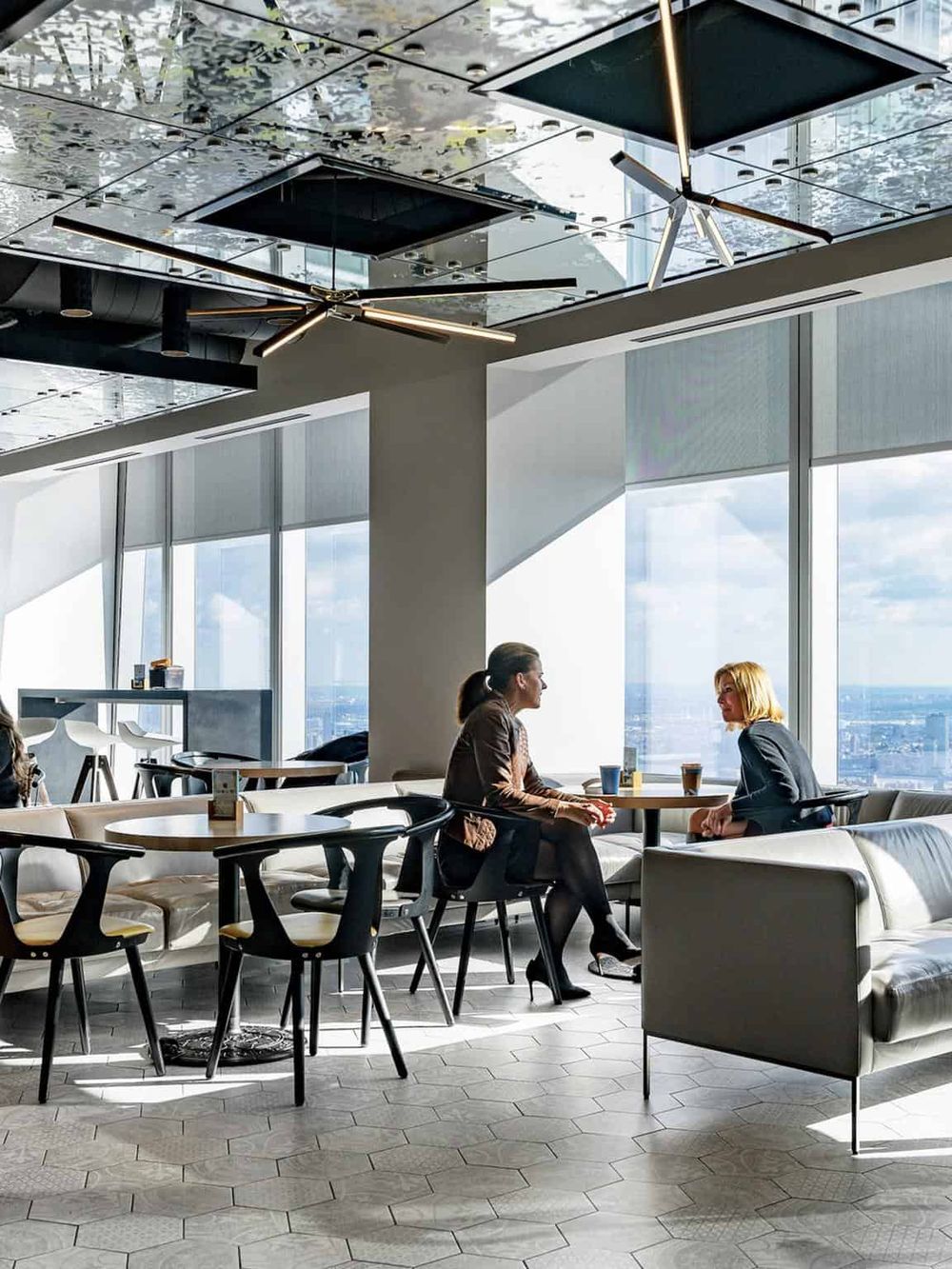 Modern airport lounge with large windows and contemporary decor for comfortable travel waiting.