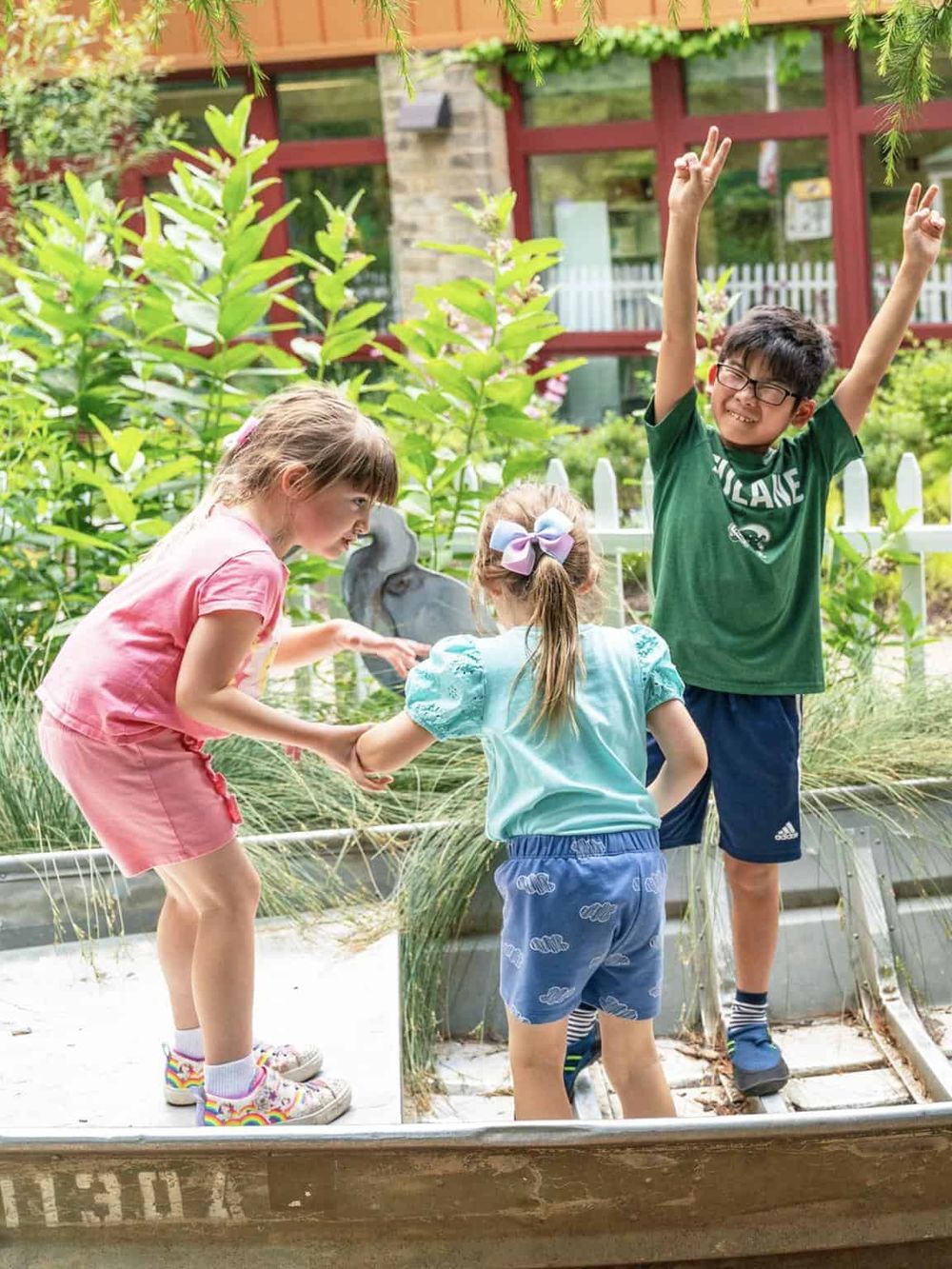 Children exploring nature at QuestForDirections outdoor activity center.
