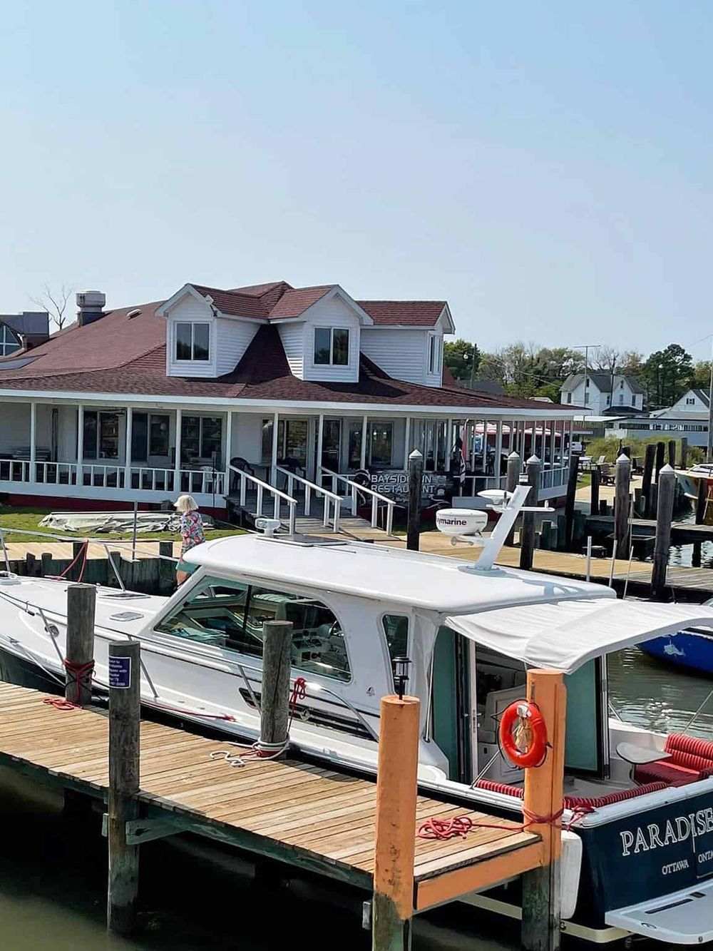 Beautiful waterfront restaurant with boat dock and marina in Bayside, offering scenic views and dining by the water.