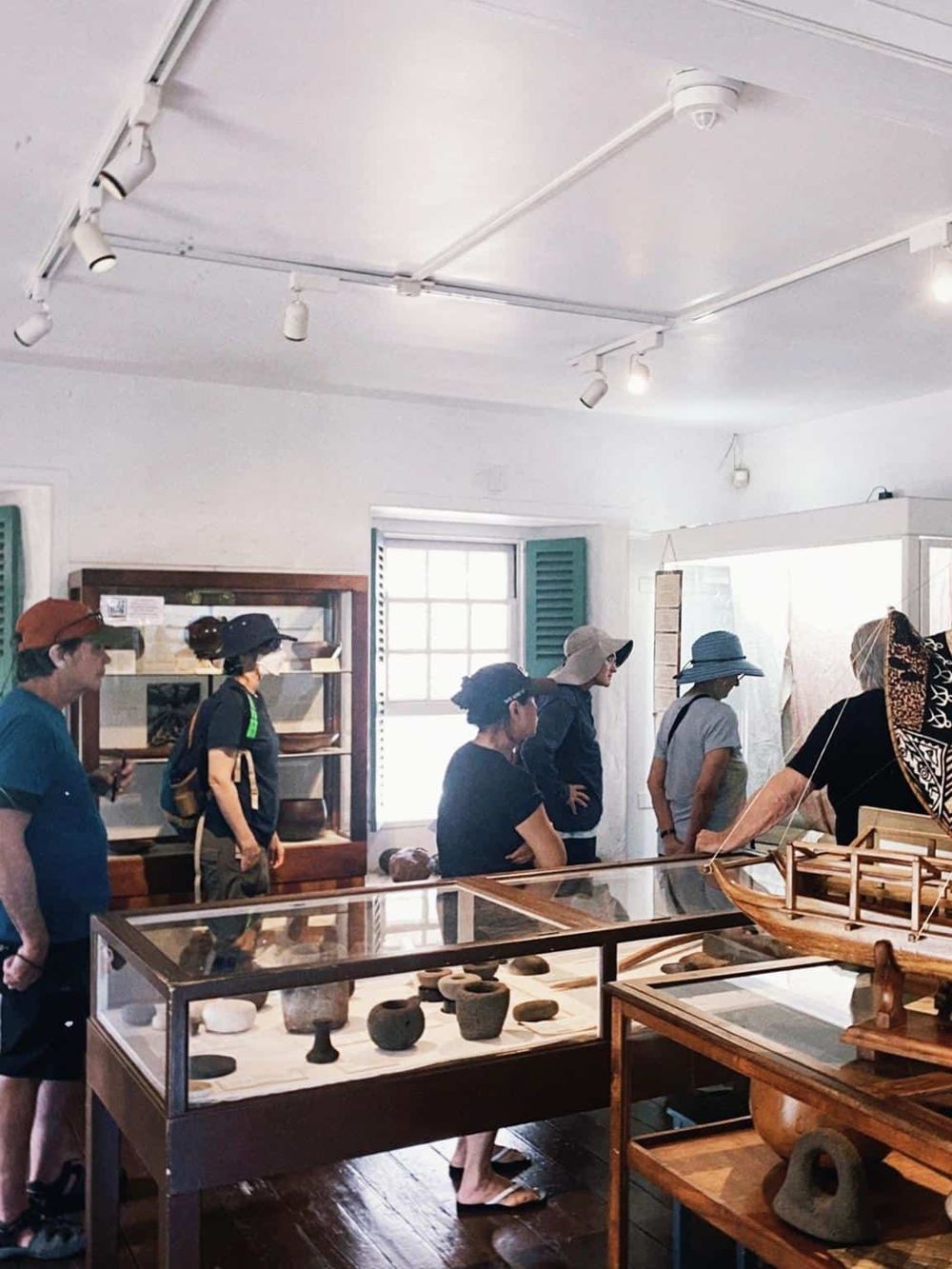 Ancient artifacts exhibit in museum, visitors exploring historical exhibits, archaeological collection display, cultural heritage showcase.