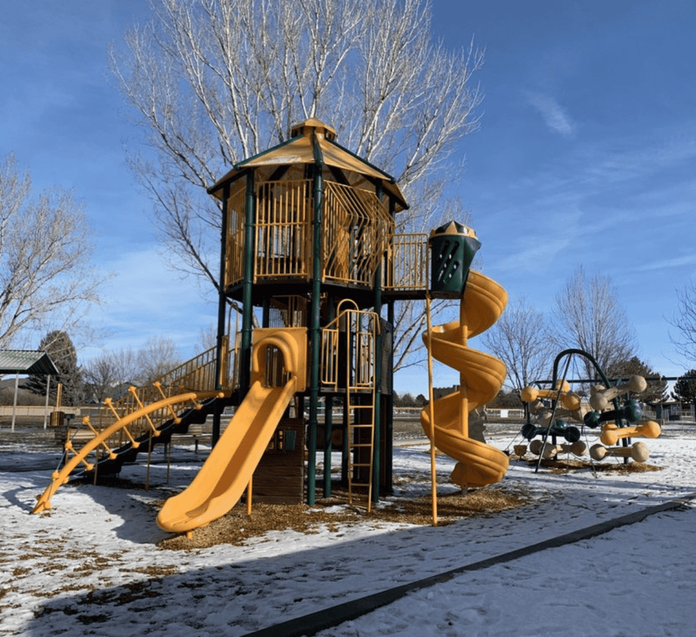 Colorful playground structure with slides at QuestForDirections outdoor park.
