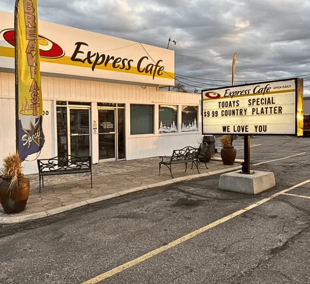 Fresh coffee and breakfast at Express Cafe in a cozy roadside setting, with parking and inviting outdoor seating.