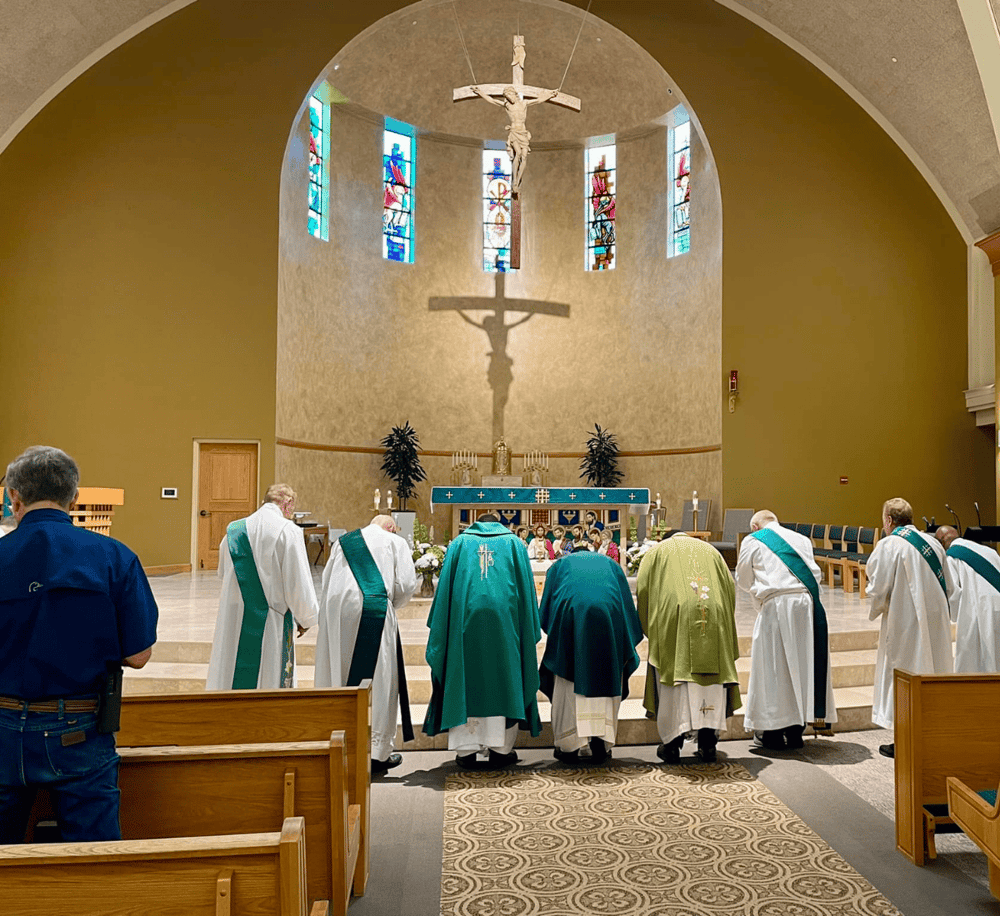 People praying inside a church during a religious ceremony.