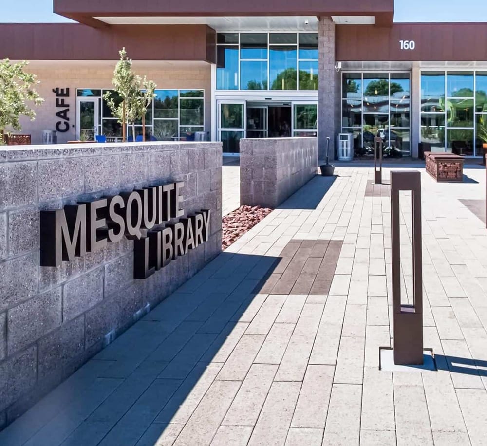 Modern Mesquite Library entrance with clear signage and outdoor seating, accessible for community and visitors.